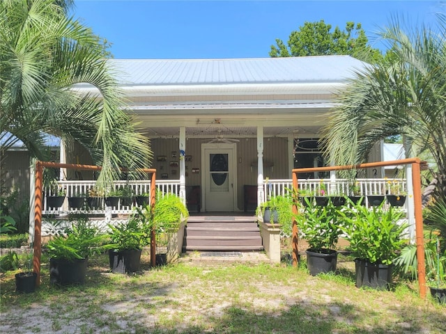 9150 SW 151st Ln, Archer, FL 32618 - view of exterior entry featuring a metal roof and a porch