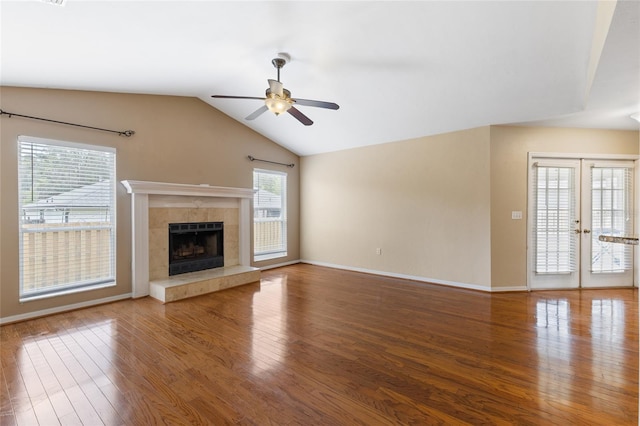 unfurnished living room featuring ceiling fan, a wealth of natural light, and wood finished floors