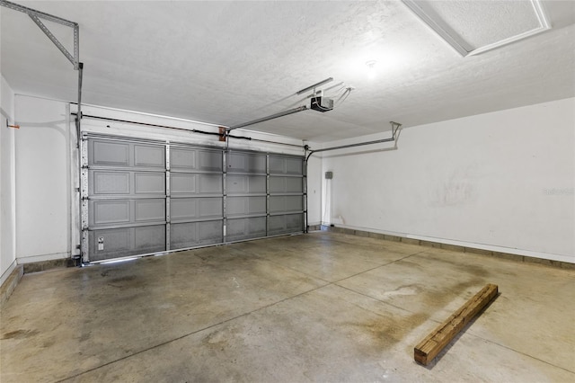 garage with baseboards and a garage door opener