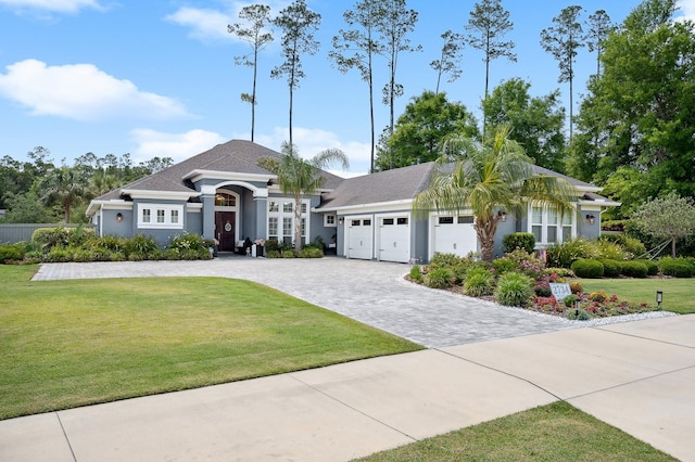 2734 SW 105th St, Gainesville, FL 32608 - view of front of home featuring a garage, decorative driveway, stucco siding, and a front lawn