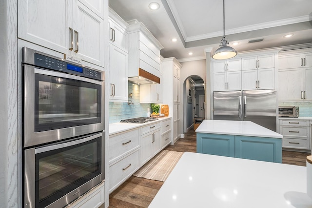 2734 SW 105th St, Gainesville, FL 32608 - kitchen with appliances with stainless steel finishes, ornamental molding, arched walkways, backsplash, and light countertops