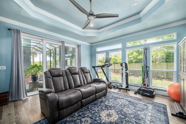 2734 SW 105th St, Gainesville, FL 32608 - living area with healthy amount of natural light, ceiling fan, a tray ceiling, hardwood / wood-style floors, and crown molding