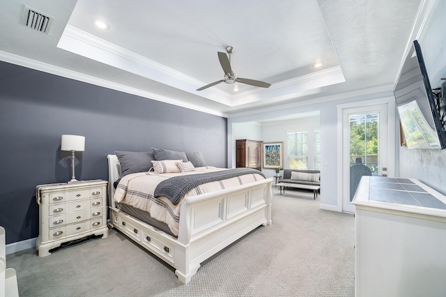 2734 SW 105th St, Gainesville, FL 32608 - bedroom with a tray ceiling, access to exterior, light colored carpet, ornamental molding, and a ceiling fan