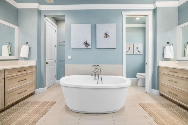 2734 SW 105th St, Gainesville, FL 32608 - bathroom featuring crown molding, vanity, tile patterned flooring, a soaking tub, and toilet