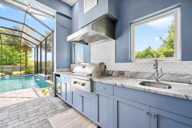 2734 SW 105th St, Gainesville, FL 32608 - view of swimming pool with grilling area, a sink, an outdoor kitchen, a lanai, and a patio