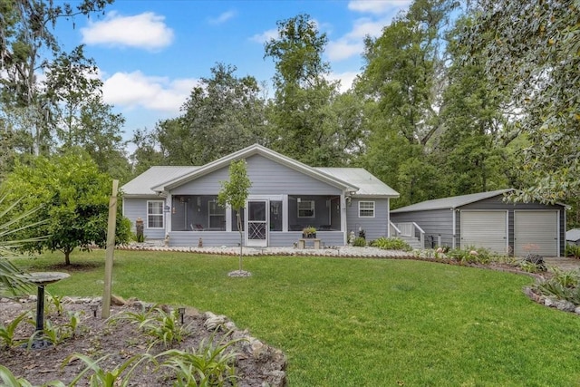 207 SW Rose Ln, Fort White, FL 32038 - rear view of property with a sunroom, a garage, a lawn, and an outdoor structure