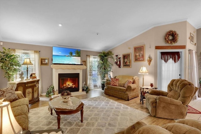 207 SW Rose Ln, Fort White, FL 32038 - living room with plenty of natural light, ornamental molding, a warm lit fireplace, vaulted ceiling, and light wood-style flooring