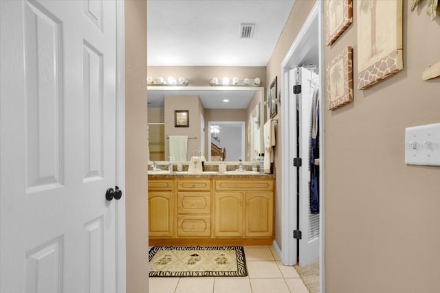207 SW Rose Ln, Fort White, FL 32038 - bathroom featuring tile patterned floors, double vanity, and baseboards