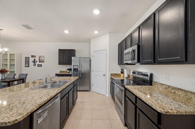 kitchen with a sink, visible vents, a chandelier, light tile patterned floors, and appliances with stainless steel finishes