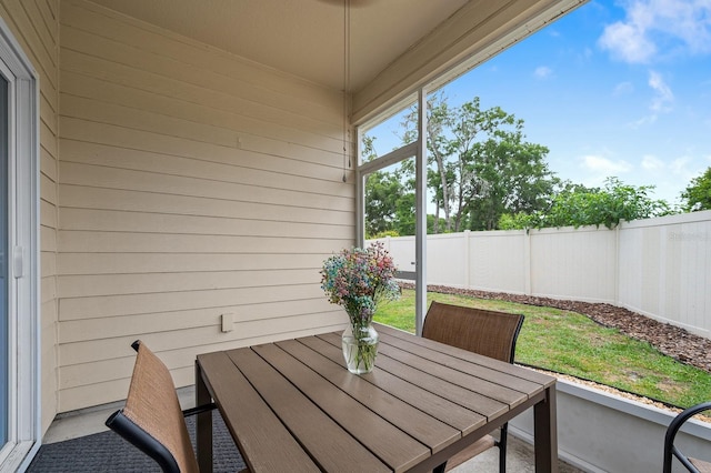 sunroom / solarium featuring outdoor dining area