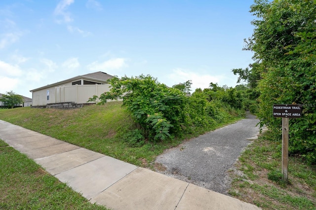 exterior space featuring a lawn and fence