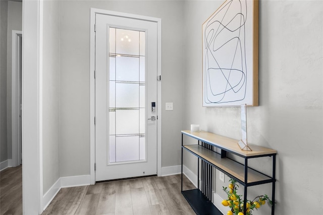 entryway featuring wood finished floors and baseboards