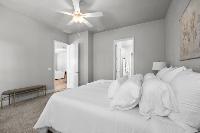 bedroom with carpet floors, ceiling fan, and ensuite bathroom