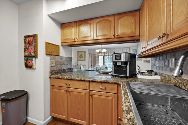 kitchen with a sink, tasteful backsplash, and brown cabinetry