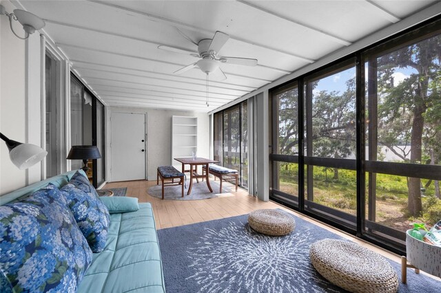 sunroom featuring hardwood / wood-style flooring and expansive windows