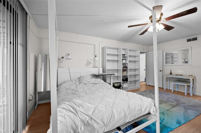 bedroom featuring wood finished floors and a ceiling fan