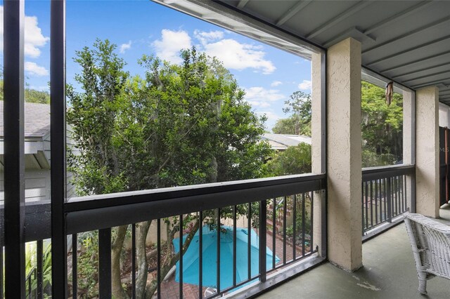 balcony featuring view of pool