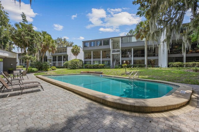 community pool featuring a yard