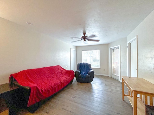 4000 SW 23rd St Unit 3-107, Gainesville, FL 32608 - living room featuring wood finished floors, ceiling fan, and baseboards