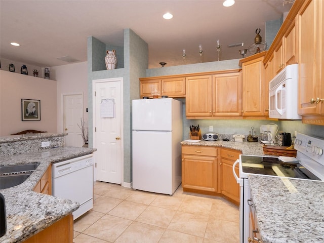 10712 SW 12th Ter, Micanopy, FL 32667 - kitchen with white appliances, light tile patterned floors, light stone counters, recessed lighting, and a sink
