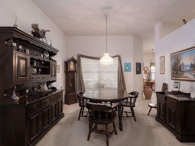 10712 SW 12th Ter, Micanopy, FL 32667 - dining room with light colored carpet and a chandelier