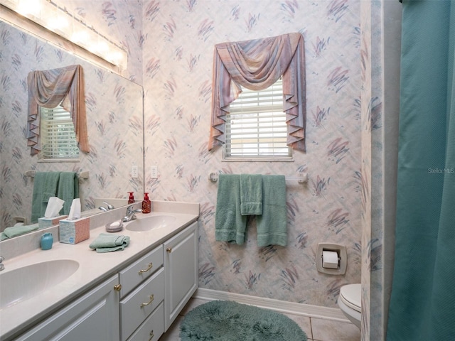 10712 SW 12th Ter, Micanopy, FL 32667 - full bath with double vanity, tile patterned floors, toilet, baseboards, and wallpapered walls
