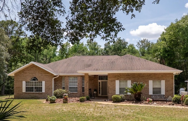 10712 SW 12th Ter, Micanopy, FL 32667 - single story home with a front yard, brick siding, and a shingled roof