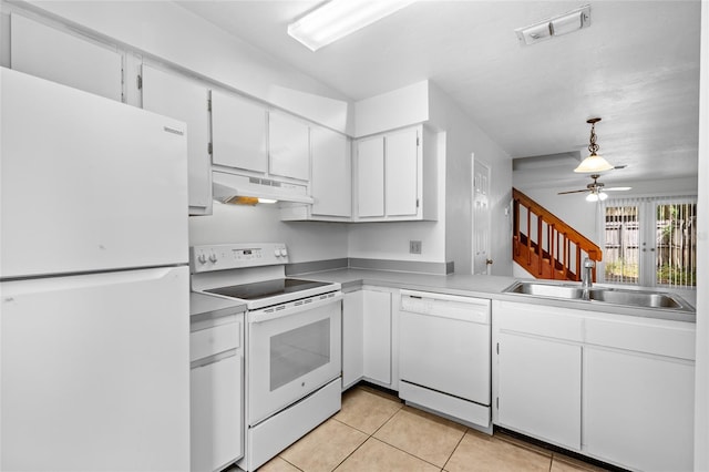 2219 SW 39th Way, Gainesville, FL 32607 - kitchen with white appliances, under cabinet range hood, a sink, light tile patterned floors, and white cabinets