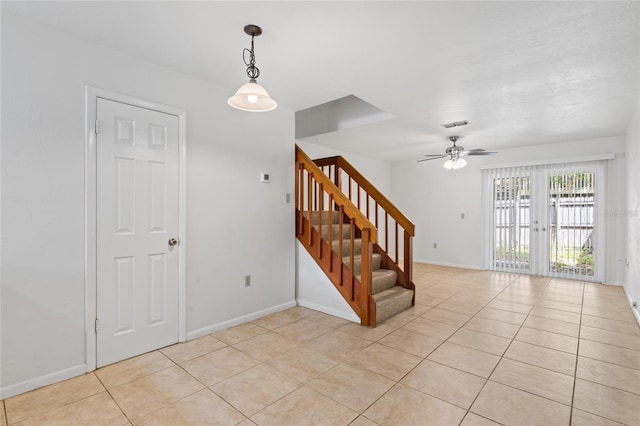 2219 SW 39th Way, Gainesville, FL 32607 - stairs with tile patterned floors, ceiling fan, and baseboards