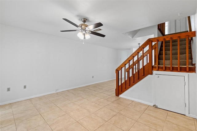 2219 SW 39th Way, Gainesville, FL 32607 - tiled empty room featuring stairway, ceiling fan, and baseboards