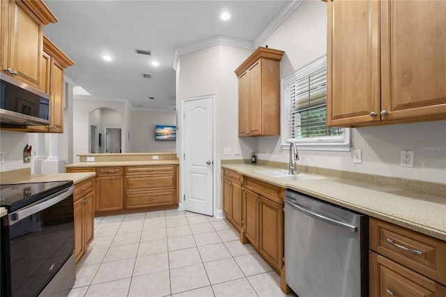kitchen featuring stainless steel appliances, a sink, ornamental molding, light countertops, and arched walkways