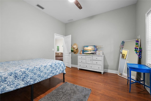 bedroom featuring wood finished floors, baseboards, and a ceiling fan