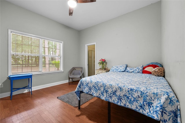 bedroom featuring wood finished floors, baseboards, and ceiling fan