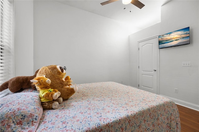 bedroom with dark wood-type flooring, baseboards, and ceiling fan