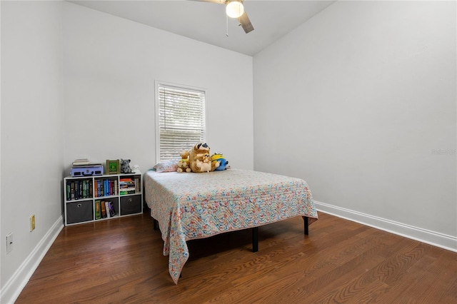 bedroom featuring wood finished floors, baseboards, and ceiling fan