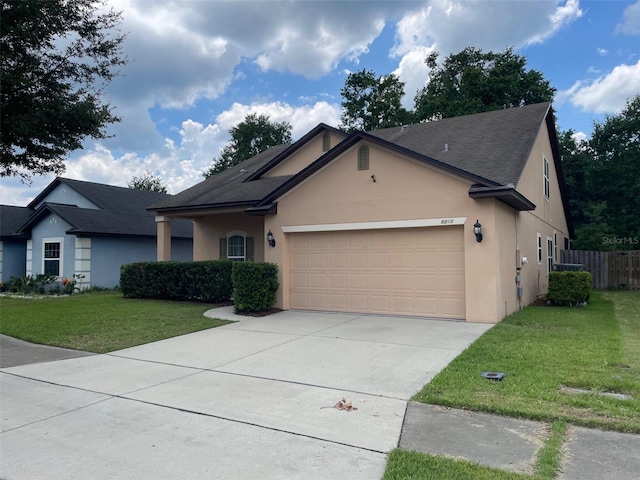 8216 NW 54th St, Gainesville, FL 32653 - ranch-style home with stucco siding, roof with shingles, an attached garage, and driveway