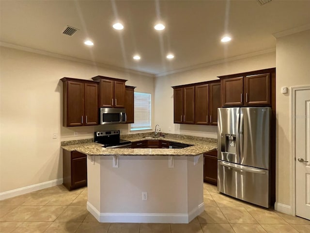 8216 NW 54th St, Gainesville, FL 32653 - kitchen featuring appliances with stainless steel finishes, ornamental molding, a kitchen island, light stone counters, and light tile patterned floors