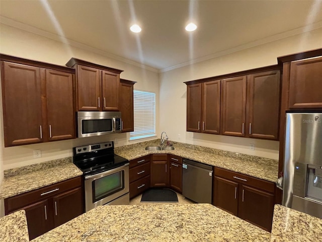 8216 NW 54th St, Gainesville, FL 32653 - kitchen with appliances with stainless steel finishes, a sink, ornamental molding, light stone countertops, and recessed lighting