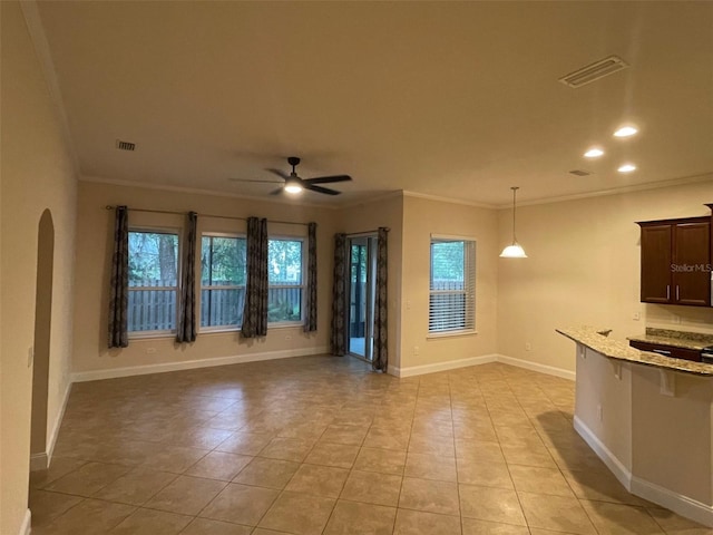 8216 NW 54th St, Gainesville, FL 32653 - unfurnished living room featuring ornamental molding, ceiling fan, light tile patterned floors, baseboards, and arched walkways