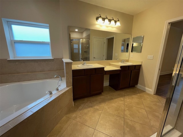 8216 NW 54th St, Gainesville, FL 32653 - bathroom with double vanity, a stall shower, a bath, tile patterned flooring, and baseboards
