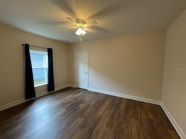 8216 NW 54th St, Gainesville, FL 32653 - spare room with dark wood finished floors, ceiling fan, baseboards, and a textured ceiling
