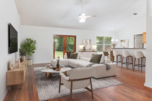 living area featuring vaulted ceiling, wood-type flooring, and ceiling fan