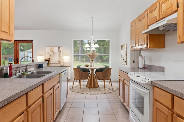 kitchen with white appliances, a sink, under cabinet range hood, a chandelier, and light tile patterned flooring