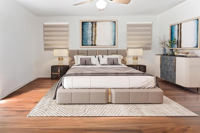 bedroom with wood finished floors, baseboards, and ceiling fan