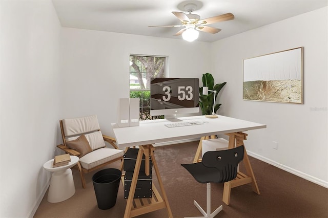 office area with baseboards, carpet, and a ceiling fan