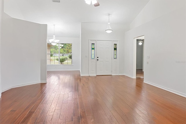 entrance foyer with hardwood / wood-style flooring, baseboards, and a chandelier