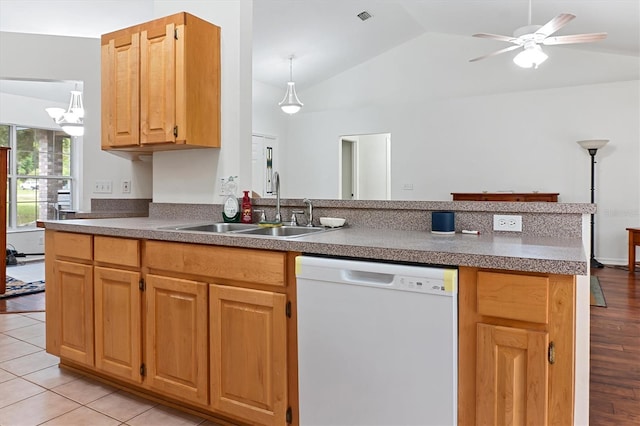 kitchen with dishwasher, a sink, vaulted ceiling, a ceiling fan, and a peninsula