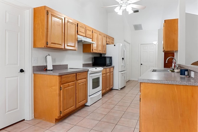kitchen featuring white appliances, a sink, under cabinet range hood, light tile patterned floors, and a ceiling fan