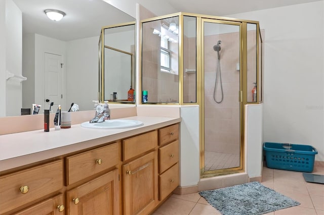 full bathroom with tile patterned flooring, a stall shower, and vanity