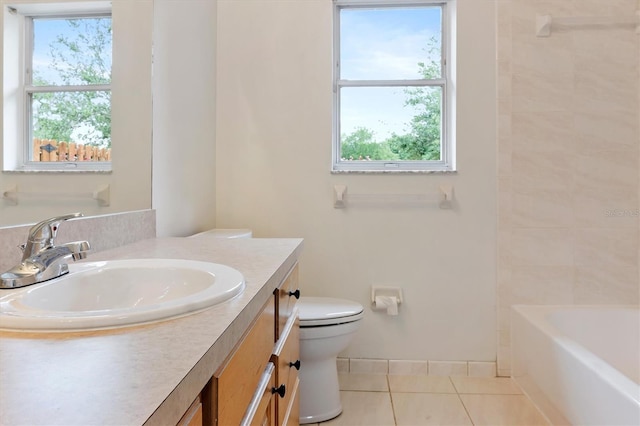 bathroom featuring tile patterned flooring, toilet, plenty of natural light, and vanity